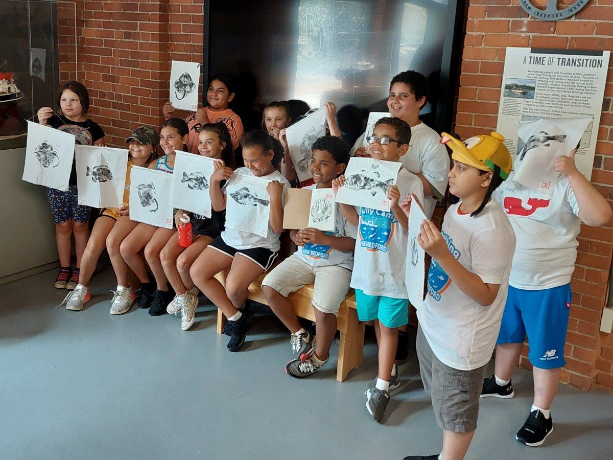 Children displaying their work during a New Bedford Fishing Heritage Center activity.