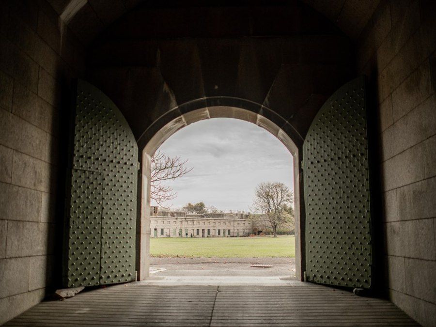 A big arched door opens to the parade ground of Fort Warren.