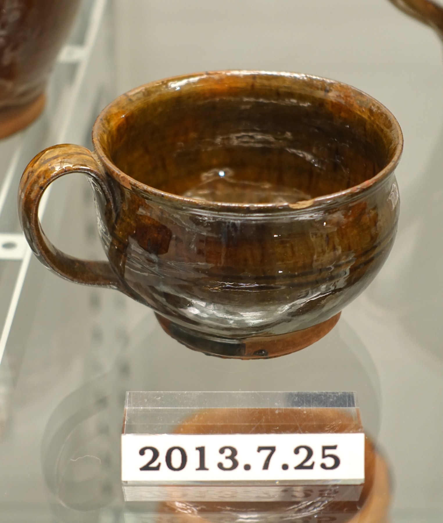 Historic redware cup from a museum collection